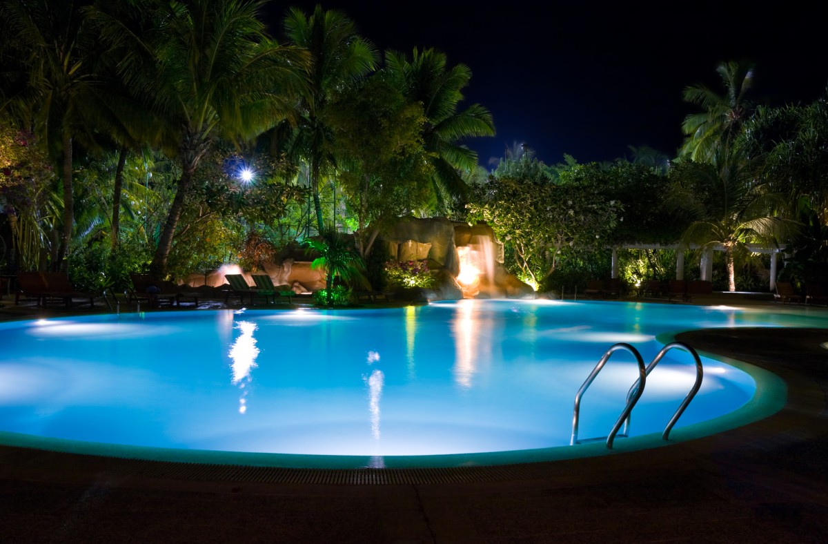 Pool and waterfall at night - vacation background